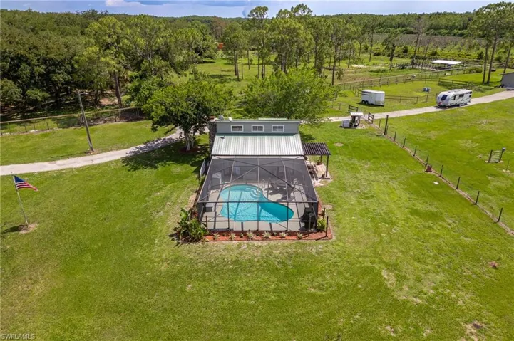 Bird's eye view of a forest and a pool area