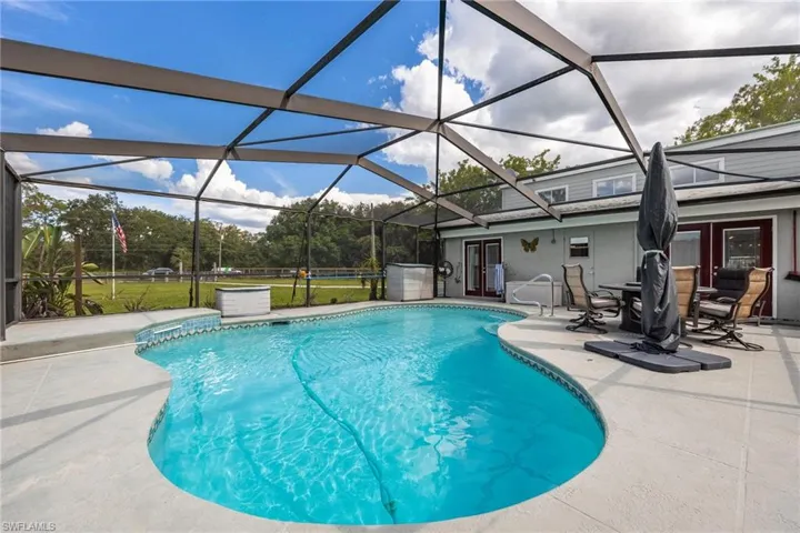 Outdoor pool featuring a patio area, french doors, and a lanai