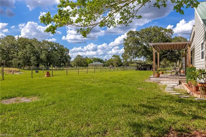 View of yard featuring a patio and a pergola