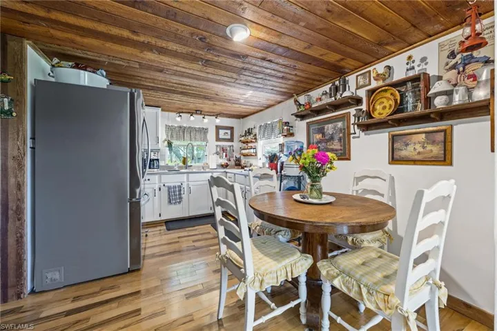 Dining area featuring wood ceiling and light wood-type flooring