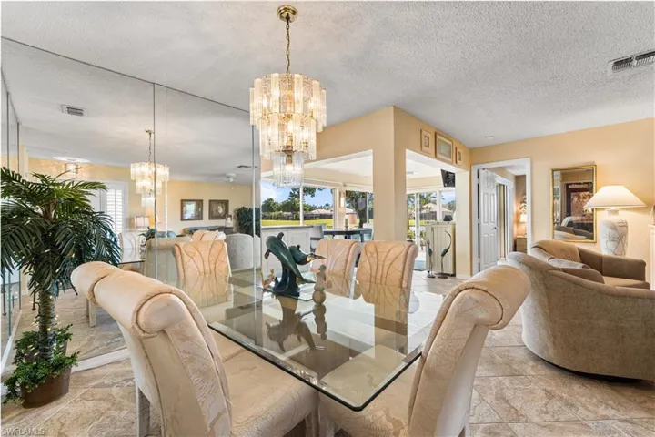 Formal dining area has views of the lake and golf course.