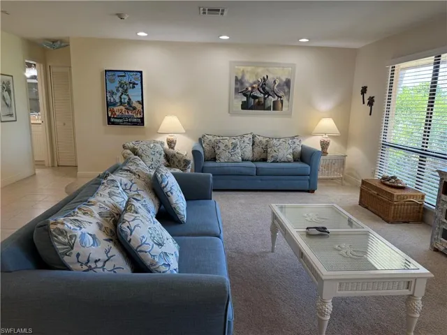 Living area with plenty of natural light and recessed lighting