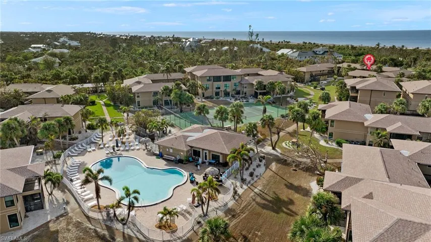 Drone / aerial view of a pool and a nearby body of water