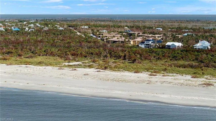 Aerial view of residential area featuring a large body of water