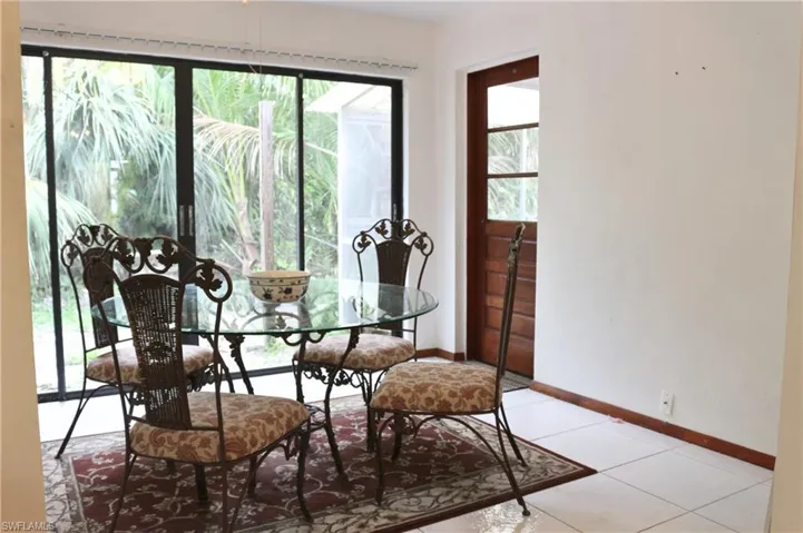 Dining area with baseboards and light tile patterned floors