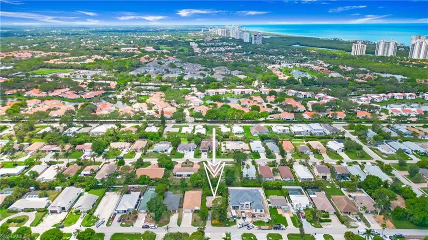 Aerial view of property's location with a large body of water