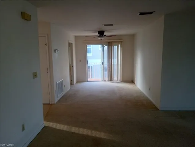 Dining / Spare room featuring ceiling fan, Balcony, enterenence to main full bathroom