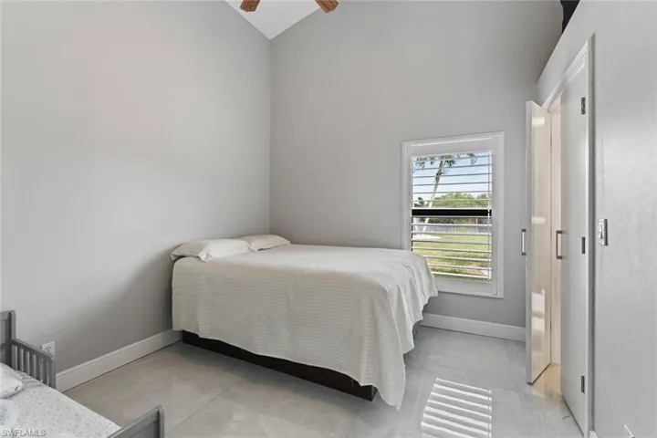 Bedroom with lofted ceiling and ceiling fan
