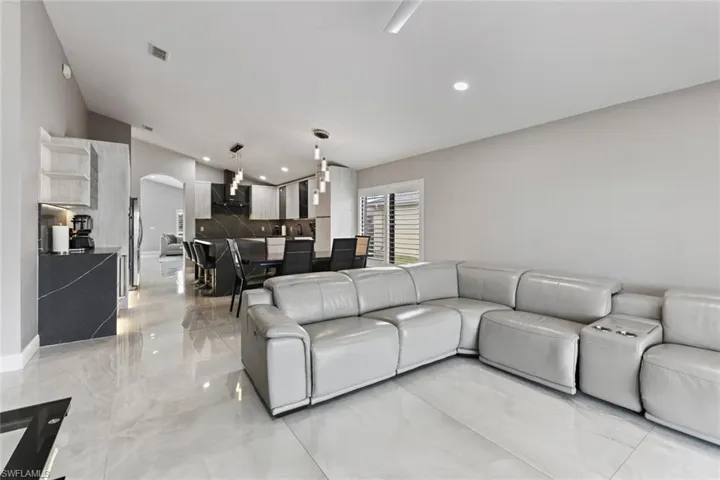 Living room with arched walkways and recessed lighting