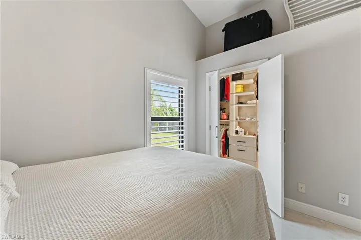 Bedroom featuring baseboards and vaulted ceiling