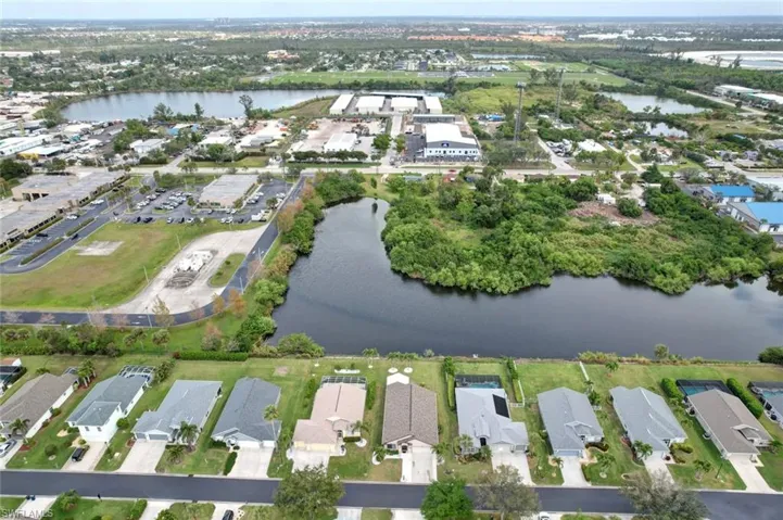Aerial view of property's location with a large body of water and nearby suburban area