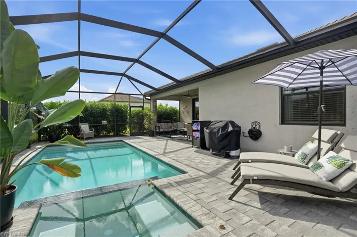 View of swimming pool featuring a pool with connected hot tub