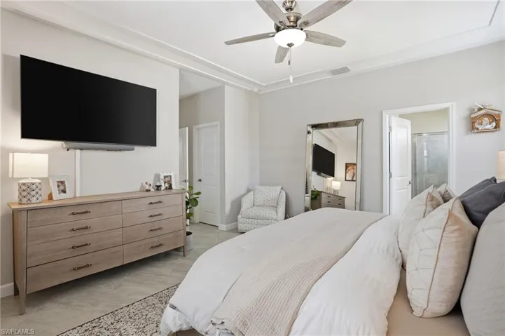 Bedroom with ceiling fan and ensuite bathroom