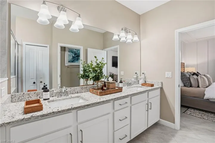 Bathroom with double vanity and connected bathroom