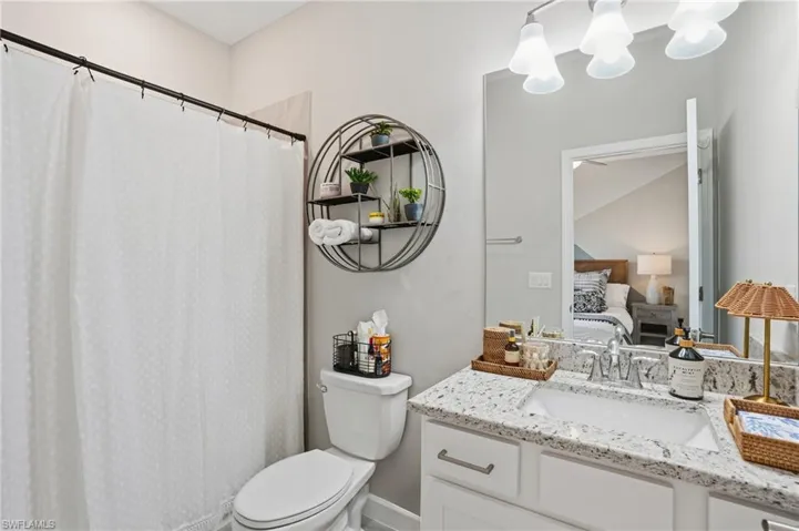 Ensuite bathroom with vanity and curtained shower