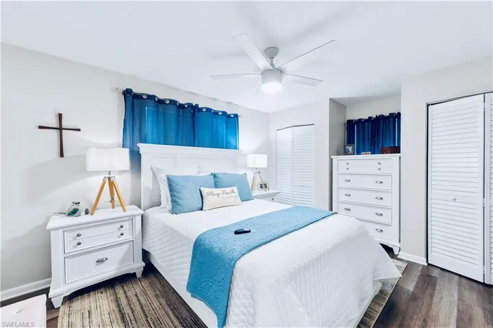 Bedroom featuring ceiling fan, a closet, and dark wood-type flooring