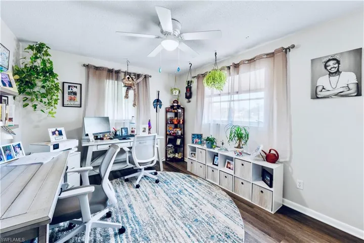 Office space featuring a textured ceiling, dark hardwood / wood-style floors, and ceiling fan