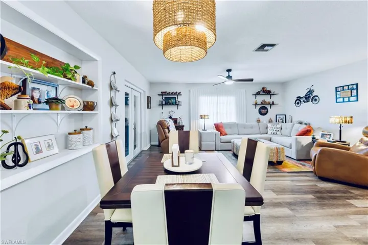 Dining space with hardwood / wood-style floors and ceiling fan