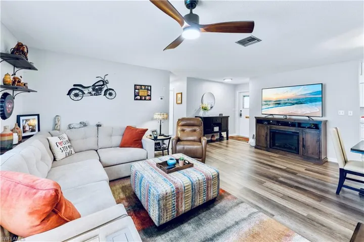 Living room with ceiling fan and wood-type flooring