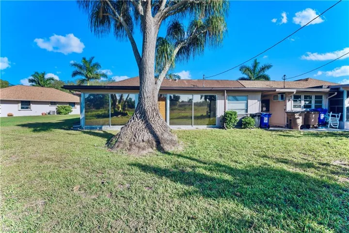 Back of house featuring a yard