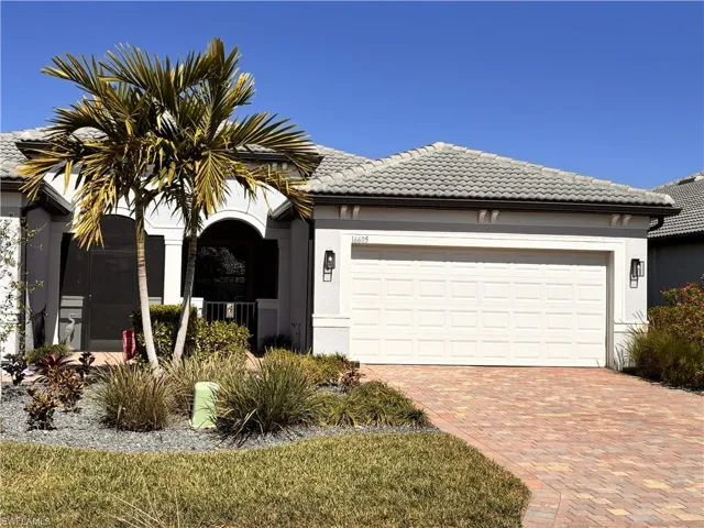 View of front of property with stucco siding, decorative driveway, a garage, and a tiled roof