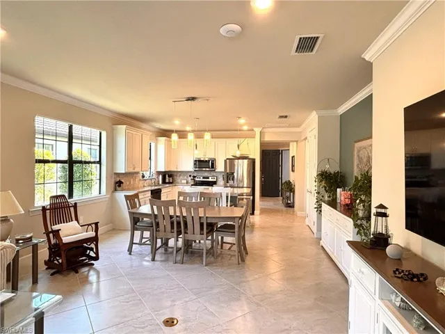 Dining room featuring crown molding and recessed lighting