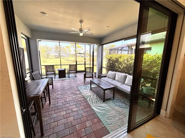 Sunroom / solarium with ceiling fan and outdoor furniture