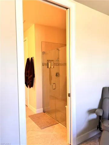 Bathroom featuring a stall shower and light tile patterned flooring