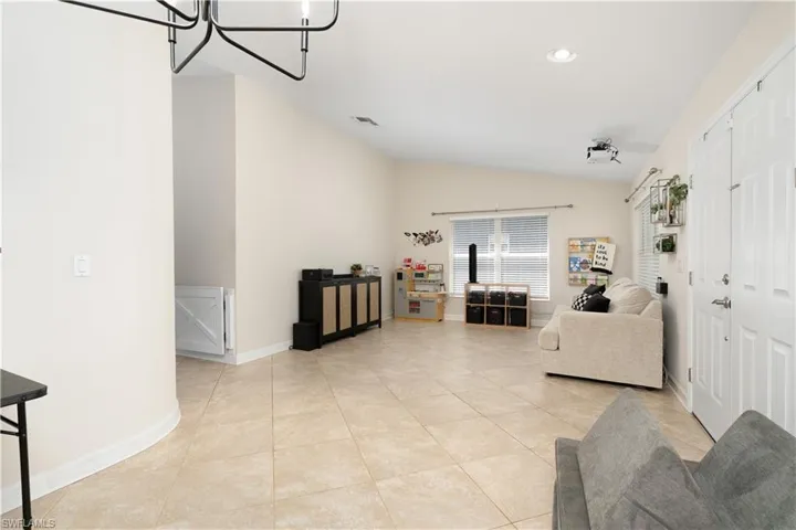 Front entry into home. Two bonus rooms on either side. Family uses one side as Playroom/Media Room. Note Epson Movie Projector mounted on ceiling is included.