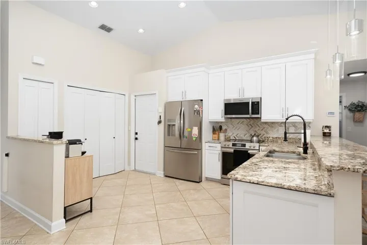 Stainless steel appliances, white cabinets, and quartz counters. Previous owners remodeled in 2024.