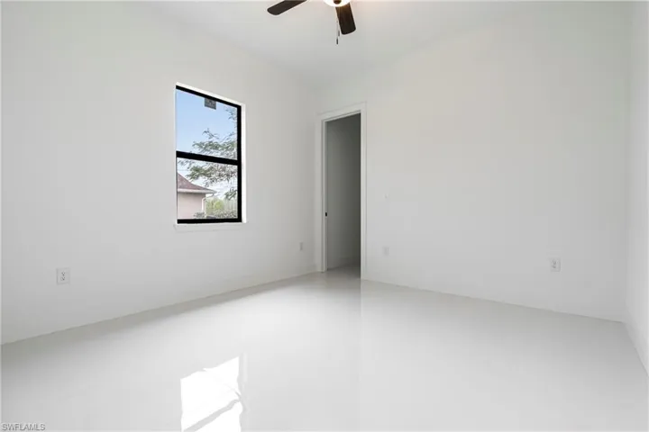 Spare room with ceiling fan and tile patterned flooring