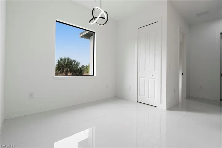 Unfurnished room featuring light tile patterned floors