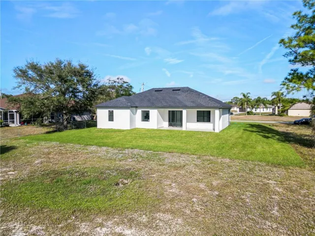 Back of property with a yard