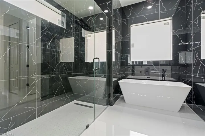 Bathroom with plus walk in shower and tile walls