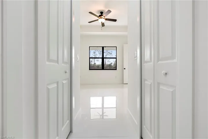Hallway with tile patterned flooring