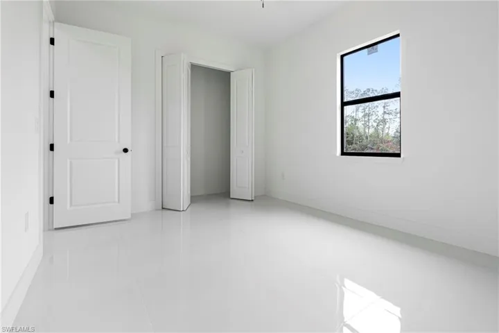 Unfurnished bedroom with light tile patterned floors and a closet