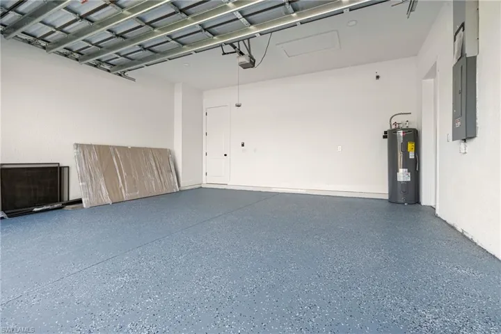 Garage with water heater and a garage door opener