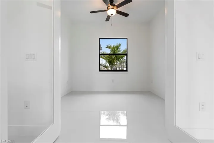 Spare room with ceiling fan