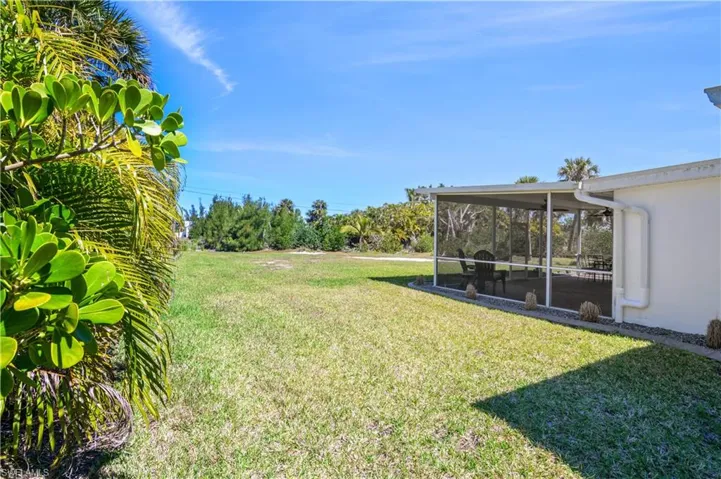 View of yard featuring a sunroom