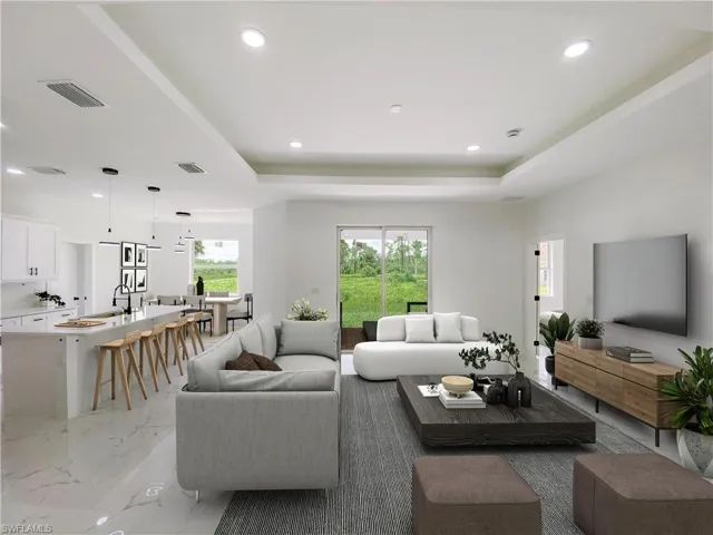 Living room featuring light marble finish floors, a raised ceiling, and recessed lighting. Photos are of a staged model or similar plan. Features and finishes may vary.