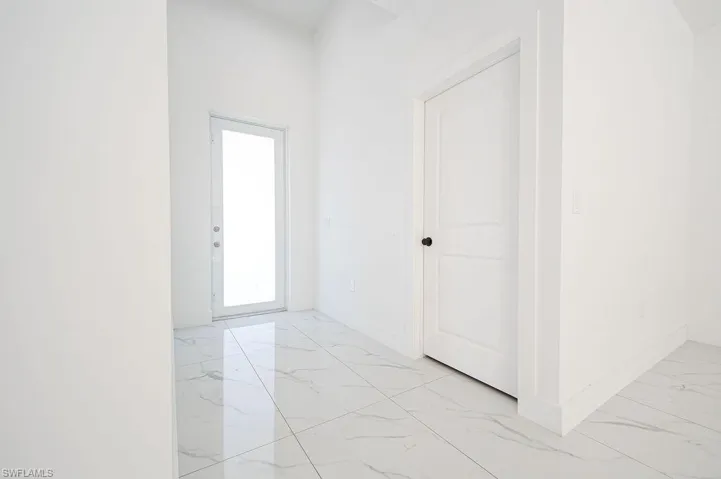 Foyer entrance with light marble finish flooring. Photos are of a staged model or similar plan. Features and finishes may vary.