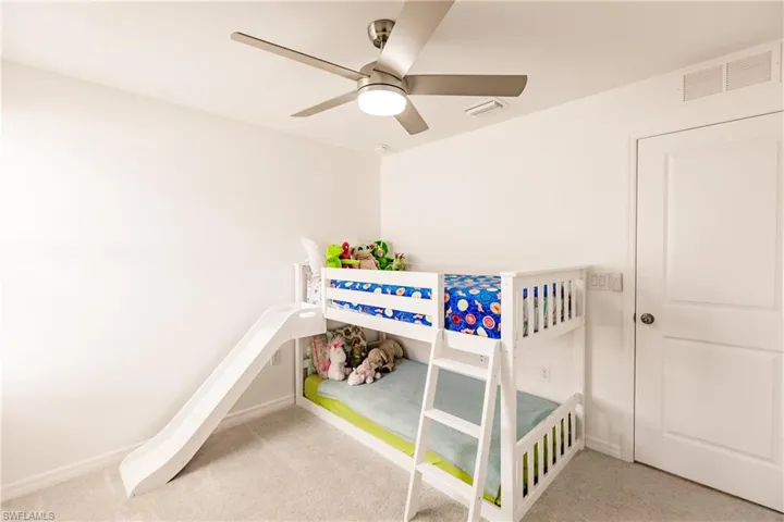 Bedroom featuring ceiling fan and carpet floors