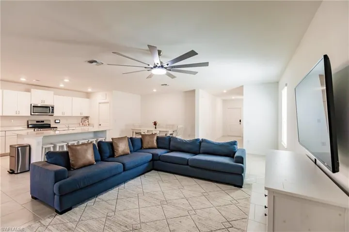 Tiled living room featuring ceiling fan