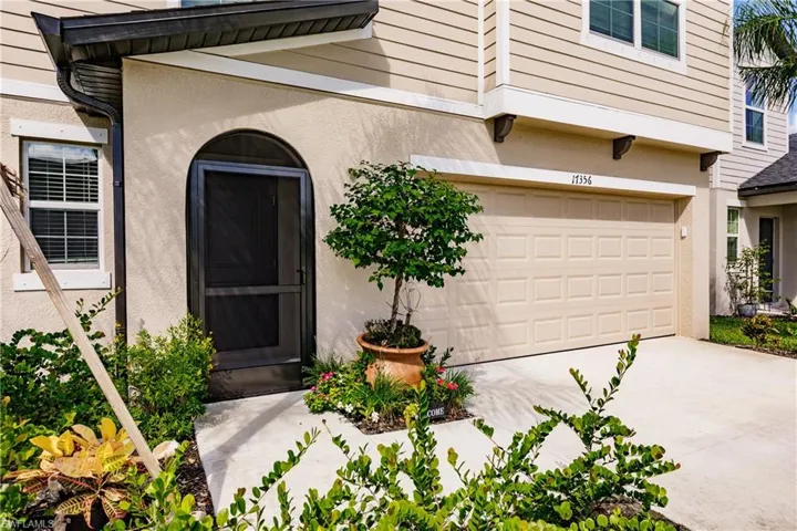 View of exterior entry with a garage