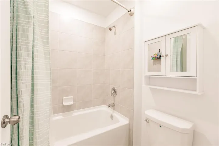 Bathroom featuring toilet and shower / tub combo
