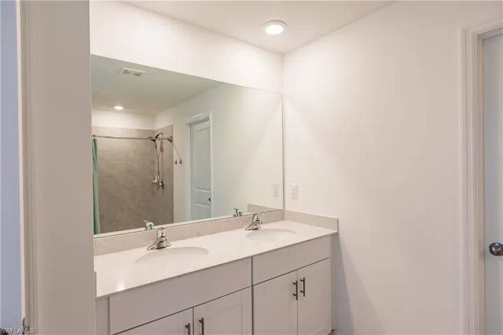 Bathroom with a tile shower and vanity