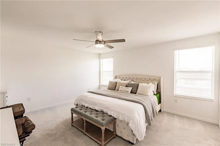 Carpeted bedroom with ceiling fan