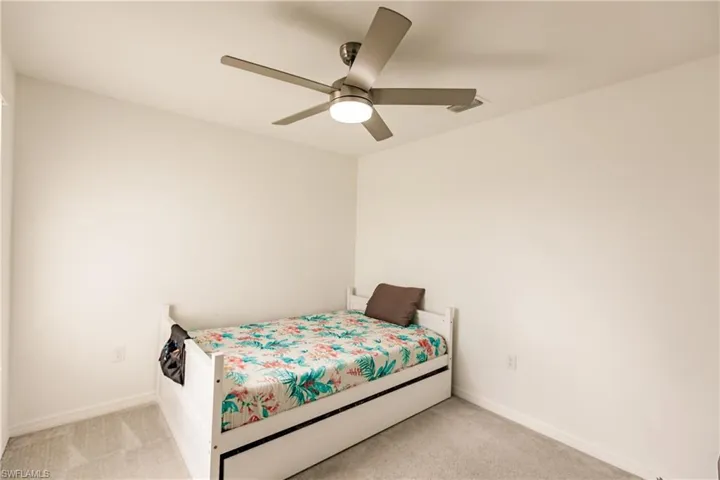 Carpeted bedroom with ceiling fan