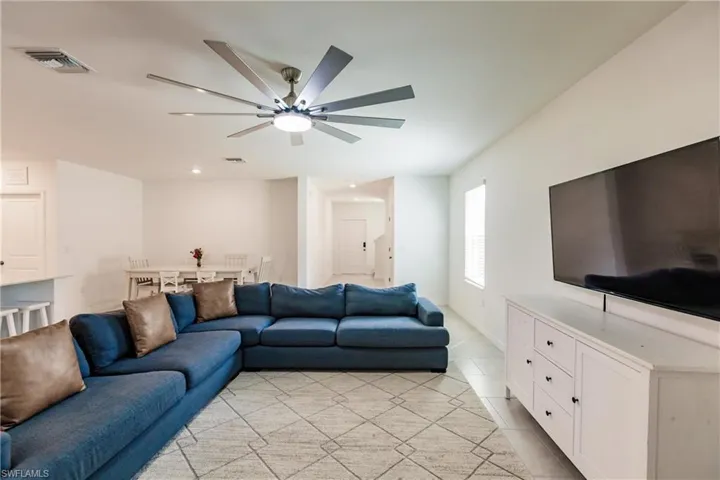 Tiled living room featuring ceiling fan