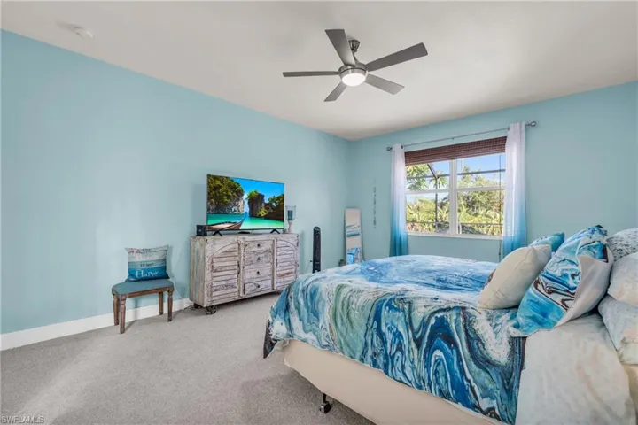 Bedroom featuring baseboards, a ceiling fan, and carpet flooring